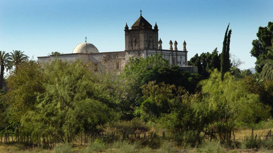 The mission at San Ignacio is visible over the green of the estuaries